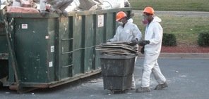 Technicians Removing Fire Damaged Debris From Home