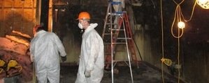 Water Damage Restoration Technician Working In Basement